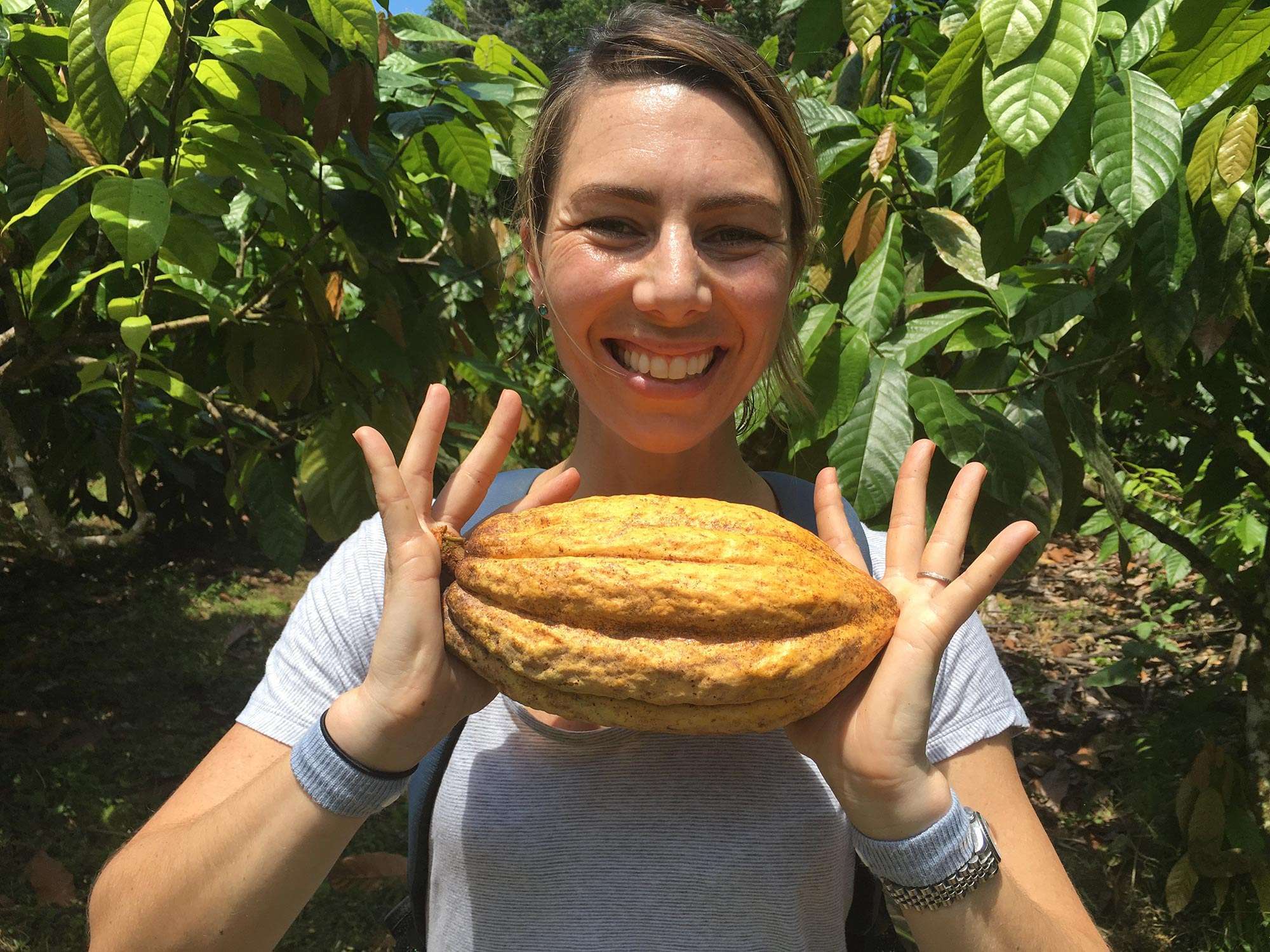 Goodnow Farms Cofounder, Monica, holds a cacao pod in Ecuador