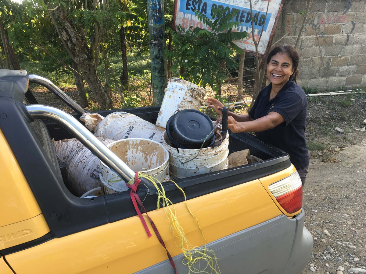 Farmer Isabel Then bringing wet cacao (baba) to the Zorzal fermentary.